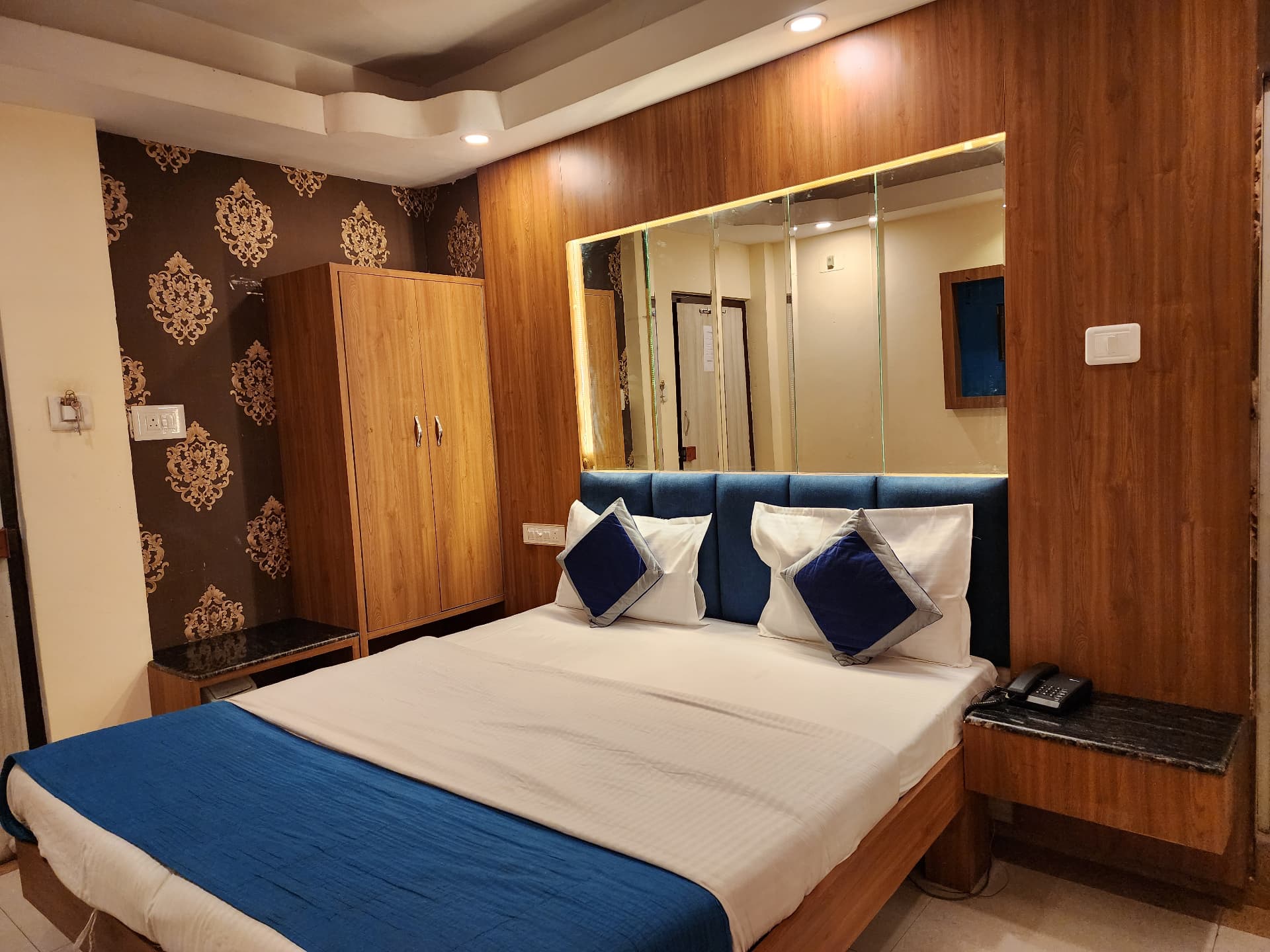 Executive Room — blue headboard, wardrobe and bedside tables