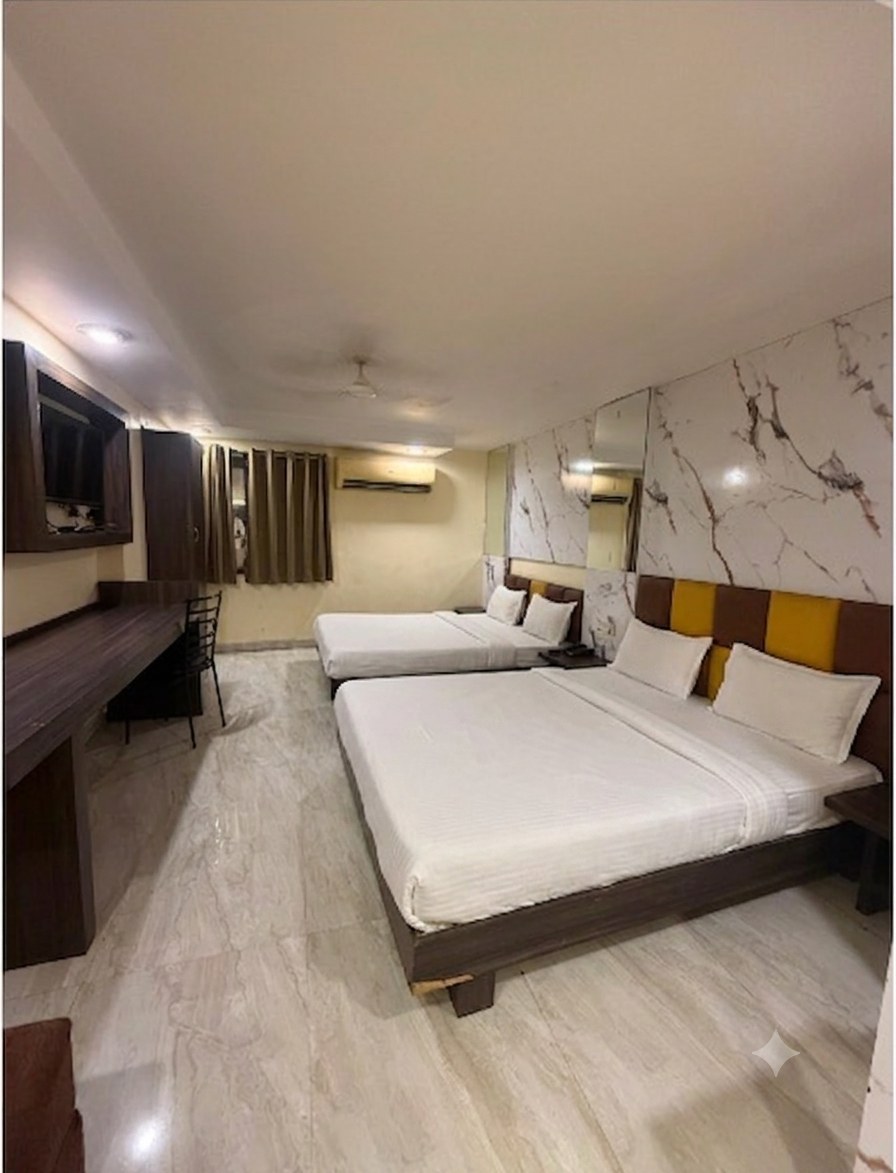 Four Bed Family Room — two double beds, marble accent wall, TV and work desk
