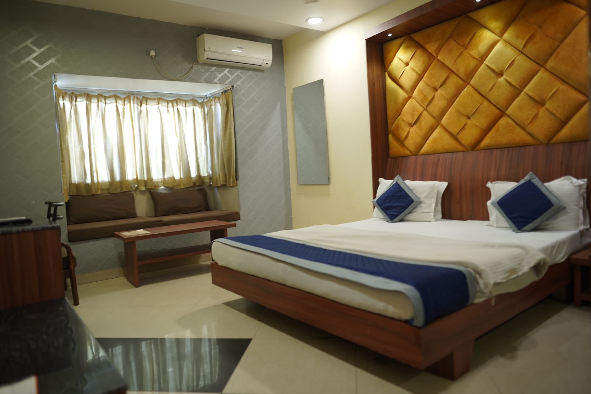 Premium Room — bed and window-side lounge seating